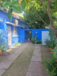 a blue house with a garden in front of it at La casa azul in Cartagena de Indias