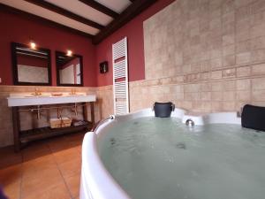 a large bathroom with a tub and a sink at Casa Número 3 in Válor