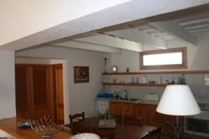 a living room with a table and a kitchen at Gemütliches Ferienhaus In Alaior Mit Privatem Pool in Cala'n Porter +18 photos