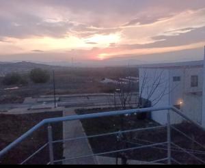 a view of a sunset from a balcony of a building at Casa para descanso y trabajo in Montero