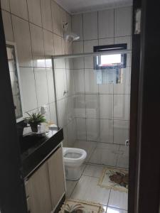 a bathroom with a shower and a toilet in it at Paraíso chama in Jaguaruna