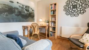 a living room with a table and a couch at Moranedd in Llanfaethlu