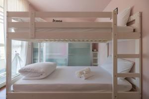 a bunk bed with two pillows on the bottom bunk at La Bomboniera di Anna in Erba