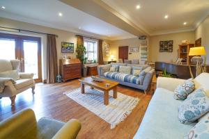 a large living room with couches and a piano at Cadshaw Country Views in Darwen