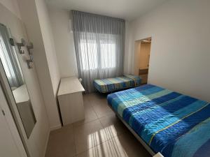 Posteľ alebo postele v izbe v ubytovaní Residence Antares - Agenzia Cocal