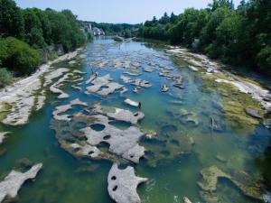 an aerial view of a river with rocks in the water at Détente au Centre-Ville - Lons-le-Saunier in Lons-le-Saunier