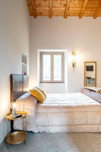 a large bed in a white room with a window at Bed & Breakfast AL 171 in Velletri