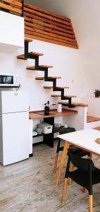 a kitchen with a wooden table and a spiral staircase at Lapachos blco cabañas in Federación