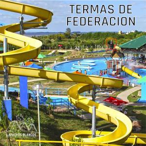 a water park with a yellow water slide at Lapachos blco cabañas in Federación