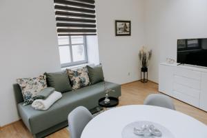 a living room with a couch and a tv at Apartmani Mesko in Gospić