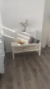 a white table with a plant on it in a bedroom at Convenient Home-stay in London