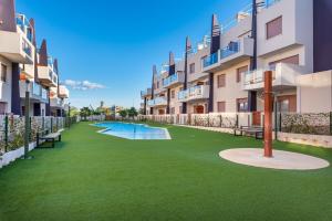 an image of an apartment complex with a green yard at Michael in Torre de la Horadada