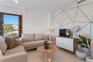 a living room with a couch and a tv at Michael in Torre de la Horadada