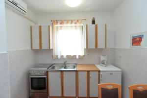 Kuchyň nebo kuchyňský kout v ubytování Apartments Slavica 590