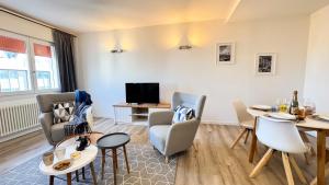 a living room with a table and chairs and a tv at Venezia Dream Stay by Ca-Sa Check in Mestre +38 photos
