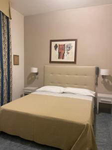 Postel nebo postele na pokoji v ubytování Hotel Ariella