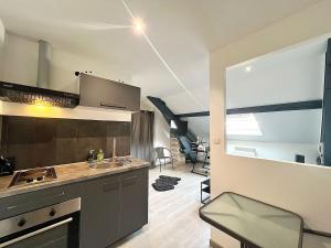 a kitchen with a sink and a counter top at Appartement moderne et central in Belfort