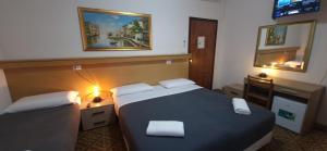 Postel nebo postele na pokoji v ubytování Hotel Tito