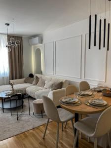 a living room with a couch and a table and chairs at Zlatkovic Family in Pirot