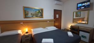 Postel nebo postele na pokoji v ubytování Hotel Tito