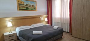 Postel nebo postele na pokoji v ubytování Hotel Tito