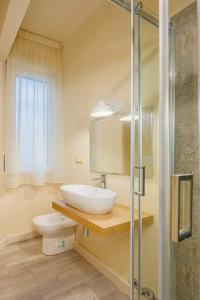 a bathroom with a sink and a toilet at Maffi's Apartment - Steps from Pisa Tower in Pisa