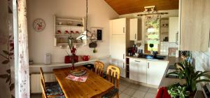 una cucina con un tavolo di legno e una sala da pranzo di Hundefreundliches Haus Austernperle In Sehestedt a Sehestedt