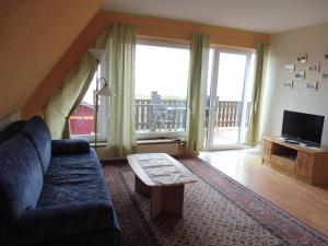 a living room with a couch and a large window at Geräumige Ferienwohnung In Radewege Mit Eigenem Balkon in Radewege