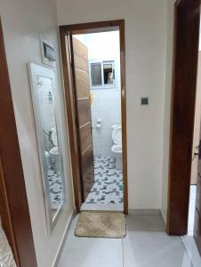 ein Badezimmer mit Toilette und Spiegel in der Unterkunft Résidence Angéline 4 studios in Yassa