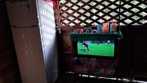 a tv on a wall with a soccer game on it at casa de descano in Belém