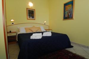 Postelja oz. postelje v sobi nastanitve Hotel Ambasciata
