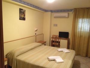 Postelja oz. postelje v sobi nastanitve Hotel Ambasciata