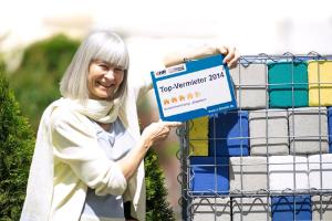 a woman holding up a sign in a basket of ties at Lollipop in Bullay