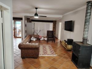a living room with a couch and a fireplace at Wakanda on Hartbeespoort Dam in Hartbeespoort