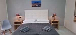 a bedroom with a large bed with pillows on it at B&B Italia in Ercolano
