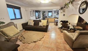 a living room with couches and chairs and a kitchen at Casa Flor, Encanto en La Rioja in Lardero