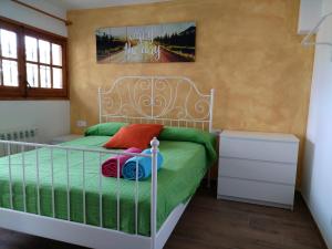 a bedroom with a bed with green and red pillows at Allotjament Bogues in Lloret de Mar +43 photos
