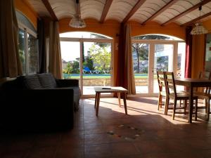 a living room with a couch and a table and chairs at Allotjament Bogues in Lloret de Mar