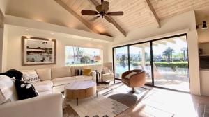a living room with a couch and a ceiling fan at Aqua Vista Spectacular Condo 2 En Suites Inspiring Views Large Patio in Rancho Mirage