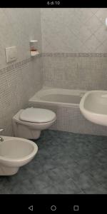 a bathroom with a toilet and a sink and a tub at Casa Vacanze Arturo in Bari