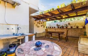 a patio with a table and a kitchen with a tableablish at Stunning Home In El Campello in El Campello +33 photos