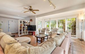 a living room with a couch and a tv at Stunning Home In El Campello in El Campello