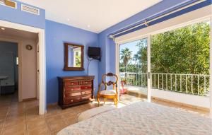 a blue bedroom with a bed and a window at Stunning Home In El Campello in El Campello