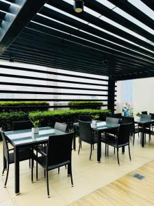 a group of tables and chairs on a patio at VINIA INFINITY STUDIO 4 near MALLS and MRT STATION in Manila