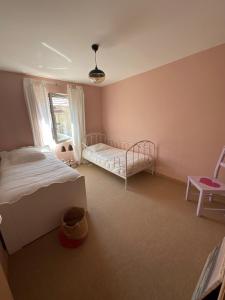 a bedroom with two beds and a window at La Lutine in Luc-sur-Mer