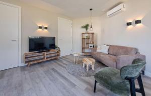 a living room with a couch and a flat screen tv at Lovely Home In Afferden With Wifi in Afferden