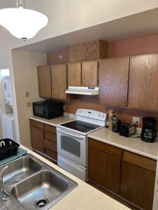 a kitchen with a sink and a stove top oven at Cozy 3-Bed Retreat in Fairbanks in Fairbanks +8 photos