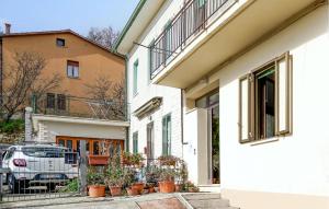 a white building with potted plants in front of it at Pet Friendly Apartment in Chianciano Terme