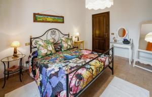 a bedroom with a bed with a colorful comforter at Pet Friendly Apartment in Chianciano Terme