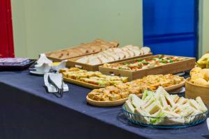 a buffet with many different types of food on a table at Brasília Tower Hotel by Castelo Itaipava in Brasilia +53 photos